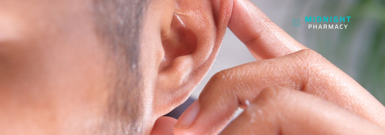 Man pointing at his ear