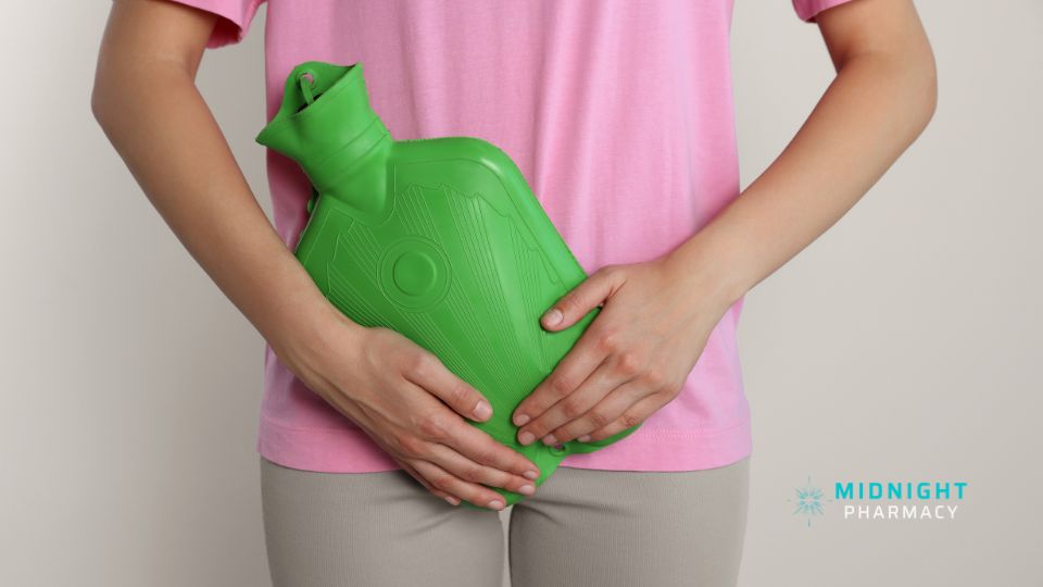 Woman holding a green water bottle over her tummy