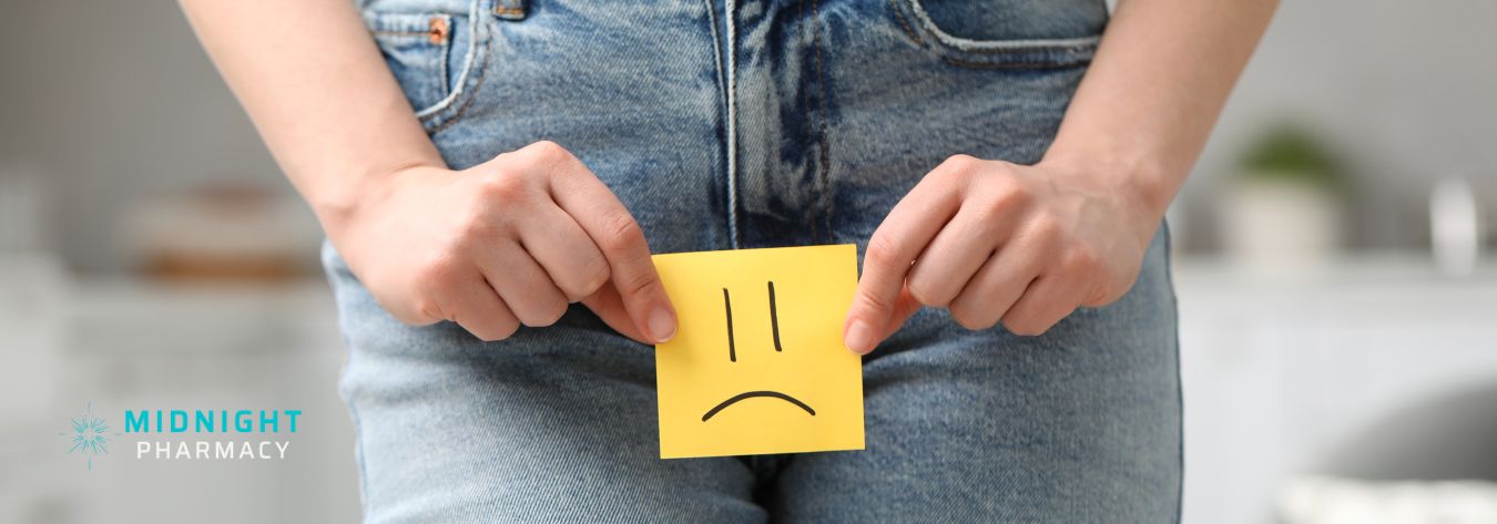 UTI illustrated by a woman holding a sad face over her jeans