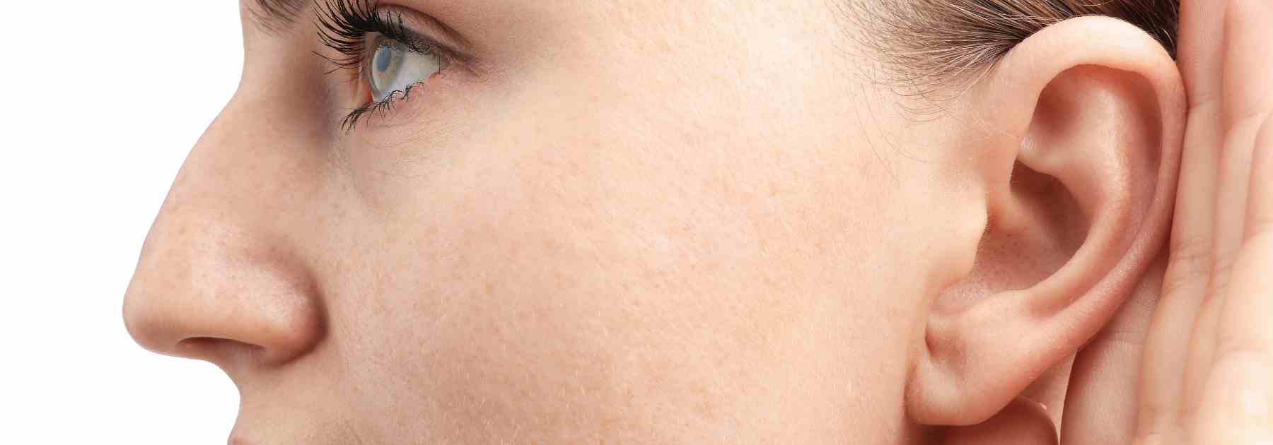 Close up image of a woman cupping her ear due to wax build up