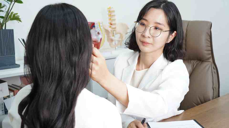 Woman getting her ear checked by a pharmacist