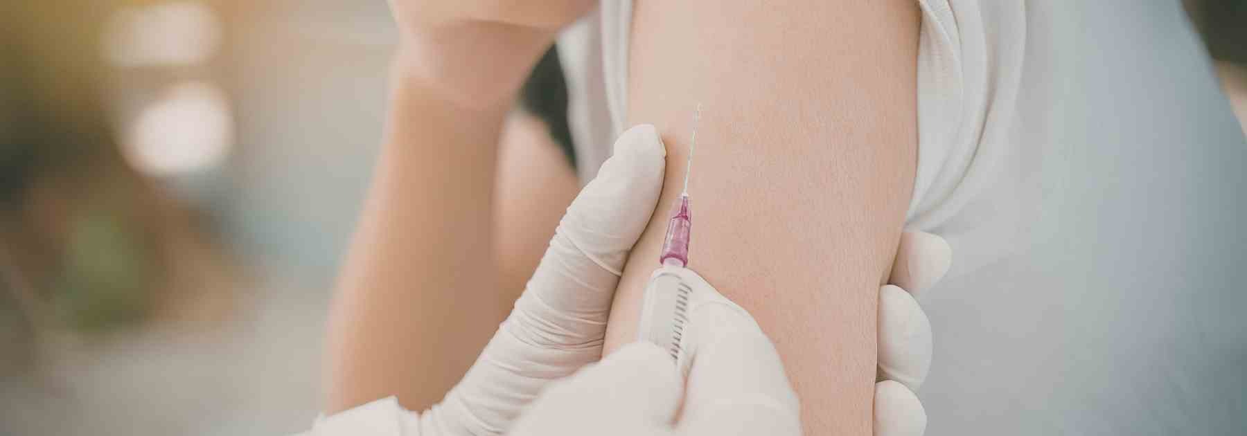 Woman getting a vaccine in the upper arm