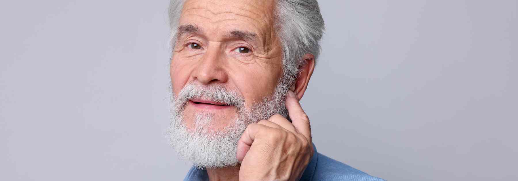 Elderly man experiencing hearing issues